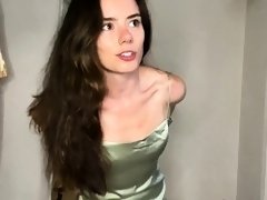 Sexy slim young brunette trying on new clothes on webcam