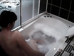 Cute teen takes a voyeur bubble bath