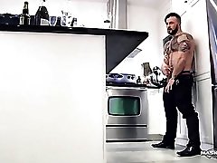 Tattooed gay god beats his meat in the kitchen